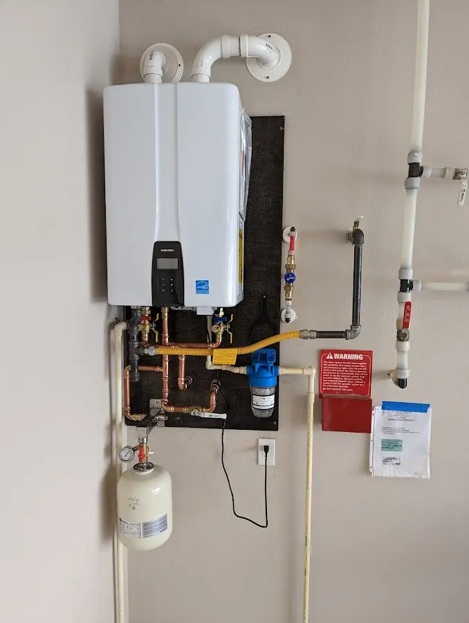 Professional plumber installing copper piping in a Fort Valley home